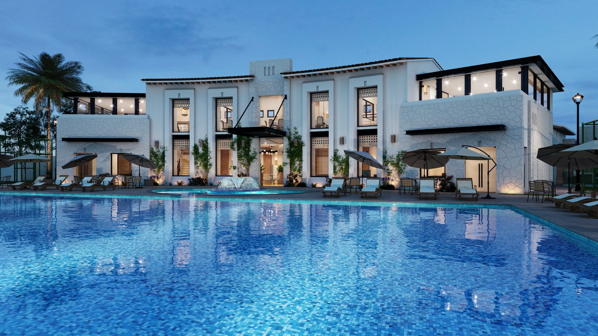 StayWell hotel exterior at dusk, surrounded by lush landscaping